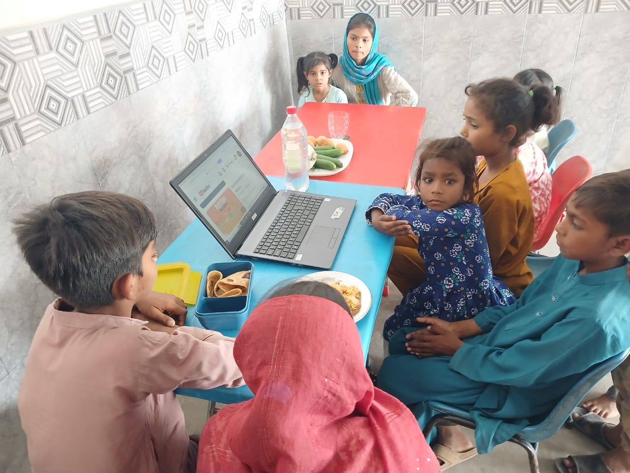 Children taking part in a supervised nutrition and healthy-living activity at Meri Pehchan