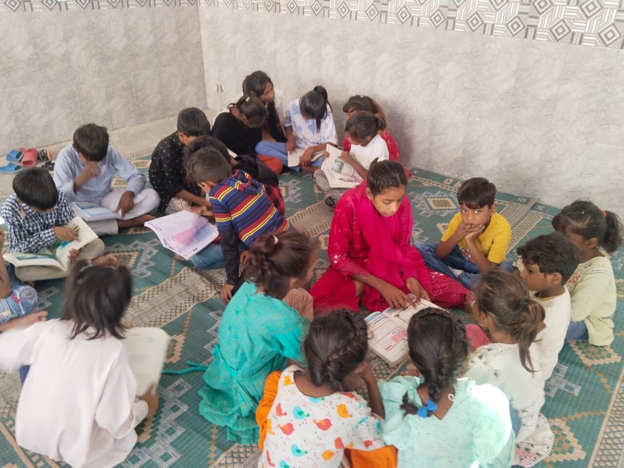 A small group of Meri Pehchan students learning together around a laptop